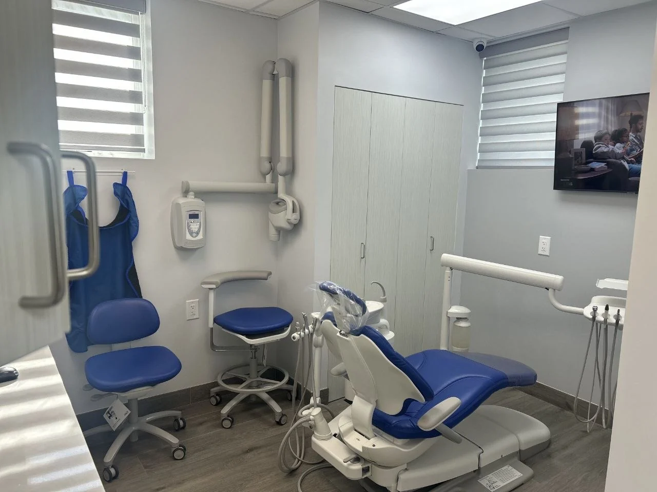 A second treatment room at BP Smiles Orthodontics, lit by two windows, with an orthodontic chair and X-ray unit.
